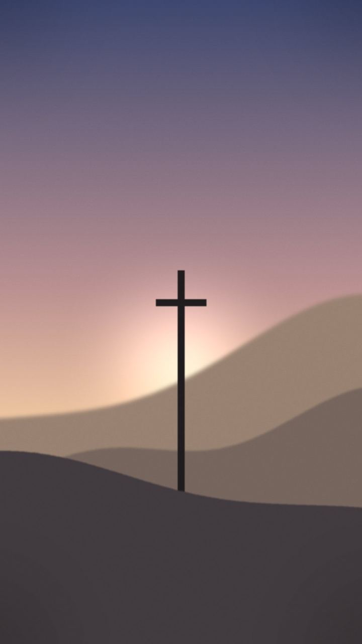 A cross on a hilltop at sunrise
